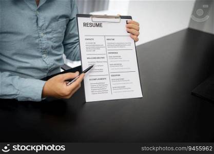 Examiner reading a resume during job interview at office Business and human resources concept