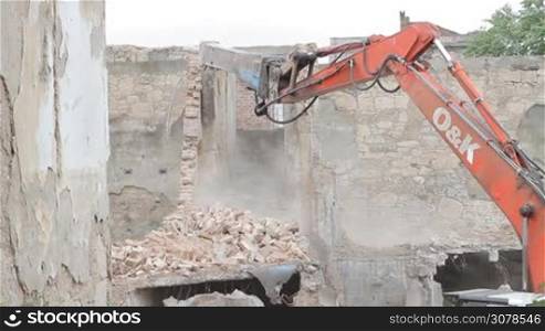 Excavator In Action, demolishing the wall