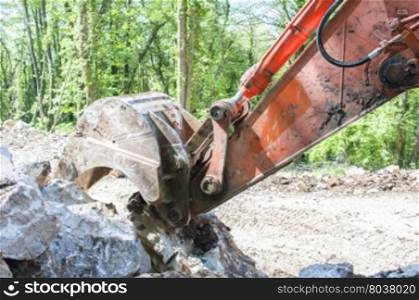 Excavator with big shovel to work with rocks