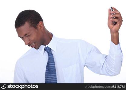 excited black man wincing and holding a cell phone in his hand