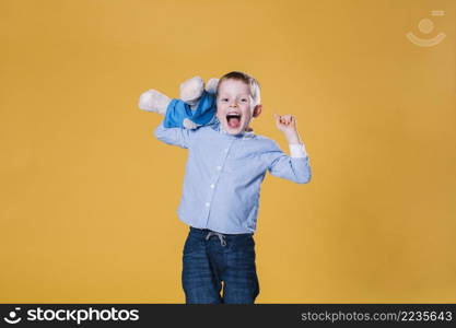 excited boy with teddy bear