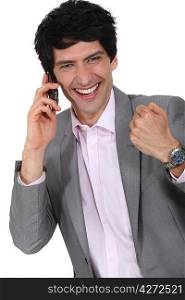 Excited businessman on the phone