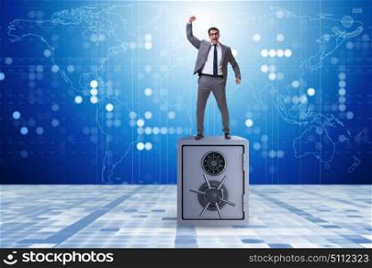 Excited businessman standing on top of safe