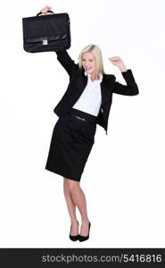 Excited businesswoman with a briefcase