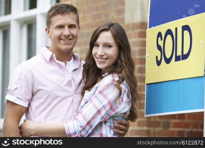 Excited Couple Outside New Home Together