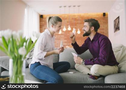 excited couple playing cards
