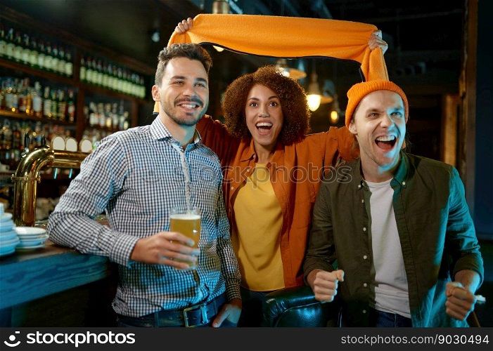 Excited diverse millennial friends gather in sports bar to watch football match online. Overjoyed hopeful fans cheering favorite team for win in game. Excited diverse millennial friends gather in bar to watch football match