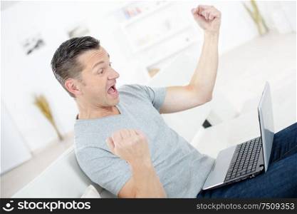 excited entrepreneur working with a laptop