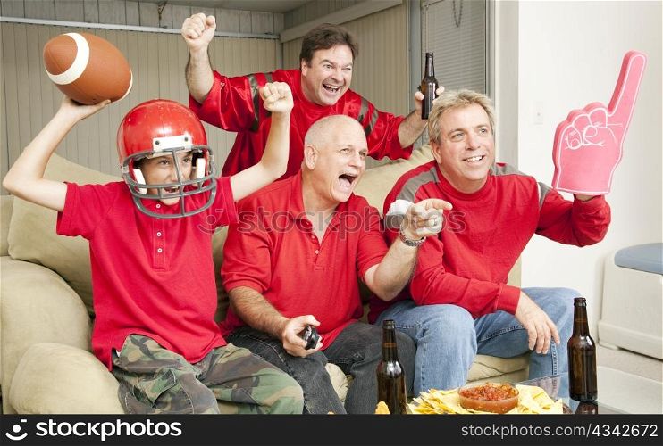 Excited football fans watching their team score a touchdown.