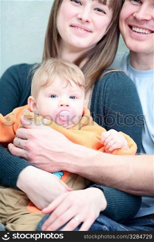 Excited happy young family of three person
