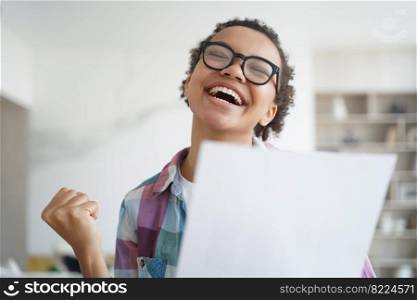 Excited happy young mixed race girl student in glasses got good news admission letter from college, makes winner yes hand gesture, holding paper document, laughing, celebrating success, achievement.. Happy mixed race girl student makes yes gesture, holding document, celebrating success, achievement