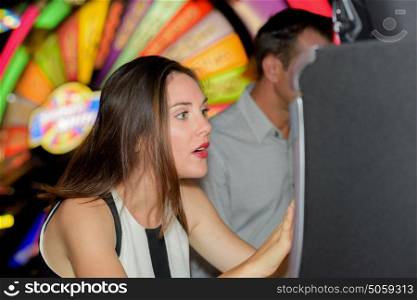 Excited lady playing arcade game