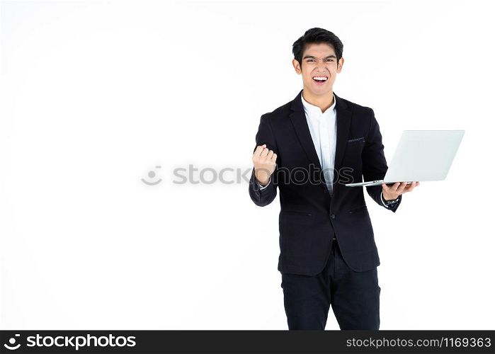 Excited overjoyed successful feeling winner screaming young Asian businessman holding working with laptop computer isolated on white grey blank copy space studio background,Business success