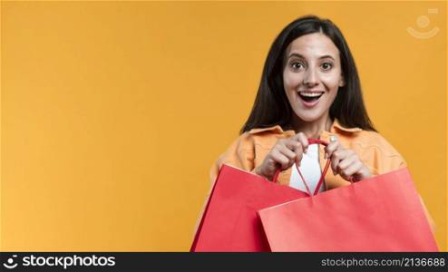 excited woman holding shopping bags with