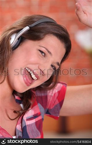 Excited woman listening to music through headphones