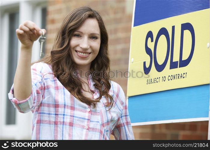 Excited Woman Outside New Home Holding Keys