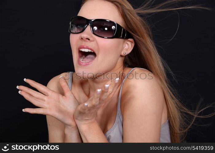Excited woman wearing sunglasses