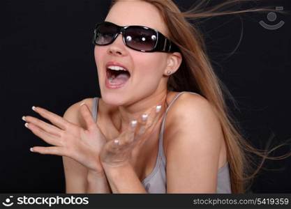 Excited woman wearing sunglasses