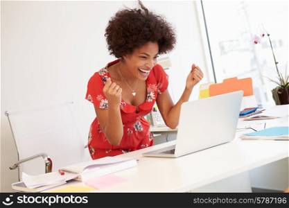 Excited Woman Working At Desk In Design Studio