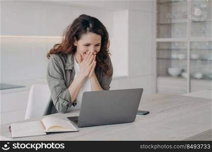 Excited young european woman has video call on laptop. Happy freelancer has corporate internet session. Hispanic girl staying home on quarantine and having good time. Businesswoman has remote work.. Excited young businesswoman has video call on laptop. Corporate internet session.