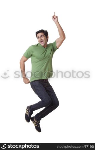 Excited young man jumping over white background
