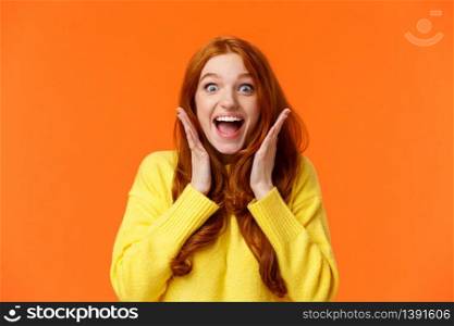 Excitement, emotions and holidays concept. Waist-up shot cheerful impressed and excited redhead woman screaming from thrill and joy, hold hands near face, open mouth and glance amazed.. Excitement, emotions and holidays concept. Waist-up shot cheerful impressed and excited redhead woman screaming from thrill and joy, hold hands near face, open mouth and glance amazed