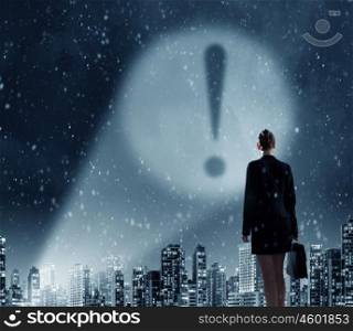 Exclamation mark in darkness. Businesswoman standing with back and exclamation mark in spotlight
