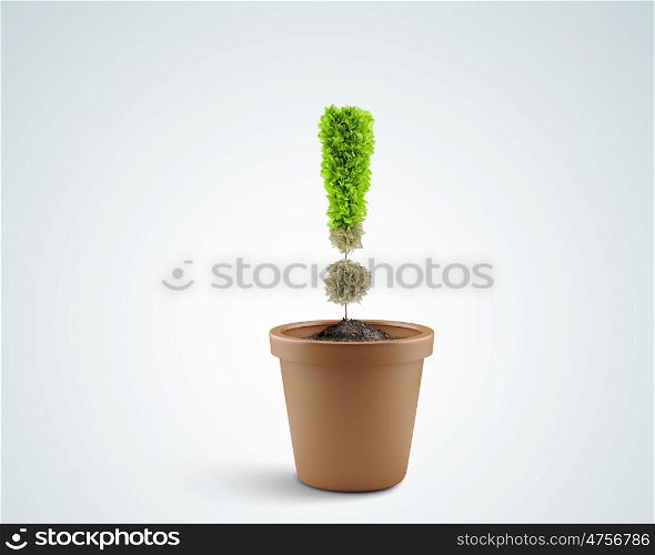Exclamation symbol. Image of pot plant shaped like exclamation sign