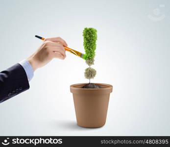 Exclamation symbol. Image of pot plant shaped like exclamation sign