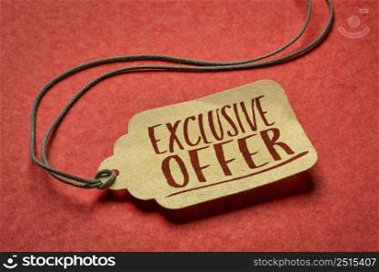exclusive offer- sign a paper price tag against textured red paper, shopping and marketing concept