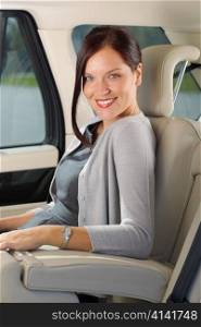 Executive businesswoman sitting in car leather backseat wear suit
