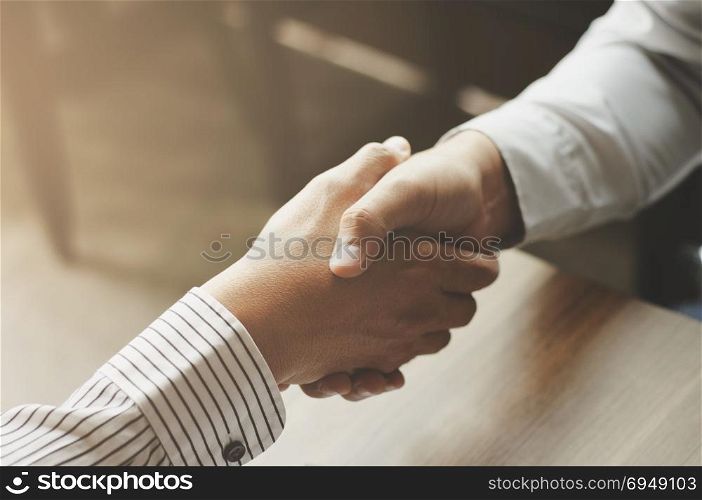 executive hand shaking at a office