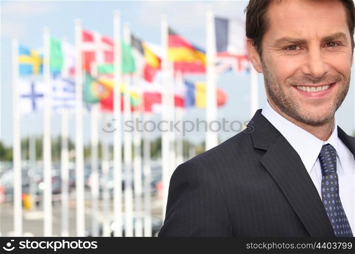 Executive in front of flags