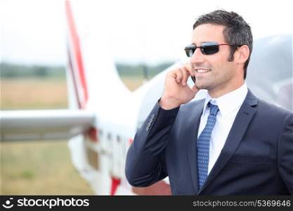 Executive in front of plane