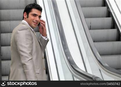 Executive on escalator
