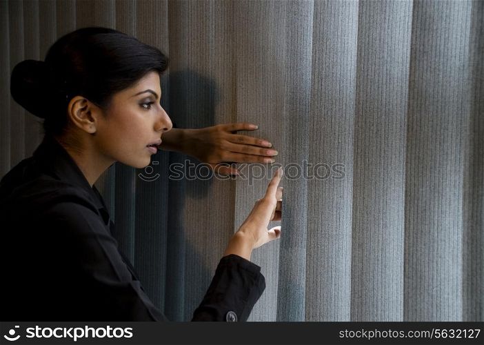 Executive peeking out the window