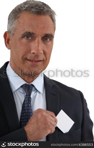 Executive removing business card from pocket