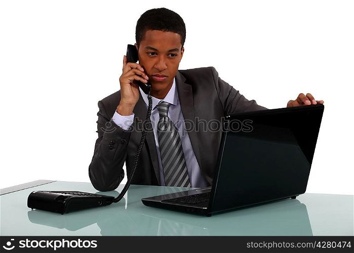 Executive with a phone and laptop