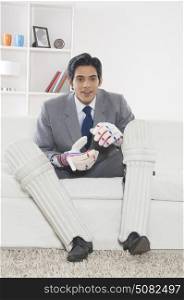 Executive with cricket gear watching match
