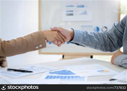 Executives consultant hands shaking in conference room.