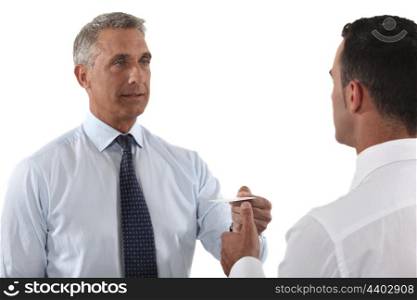 Executives exchanging business cards