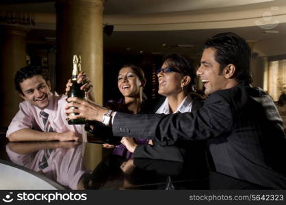 Executives holding a bottle