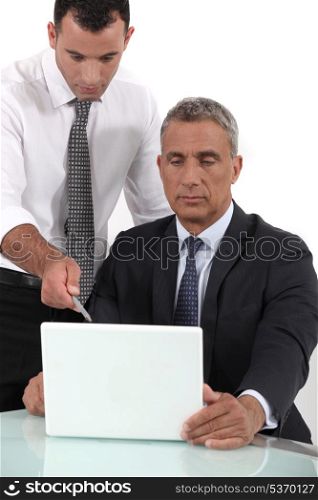 Executives looking computer project