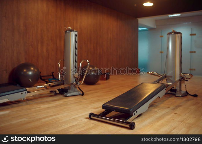 Exercise machine for pilates training in gym, nobody. Equipment for fitness workuot in empty sport club. Aerobics indoors. Exercise machine for pilates training, nobody