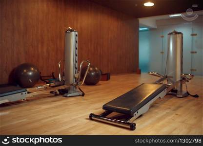 Exercise machine for pilates training in gym, nobody. Equipment for fitness workuot in empty sport club. Aerobics indoors. Exercise machine for pilates training, nobody