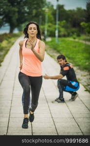 Exercising by the river with personal trainer. Female Exercising by the River with Personal Fitness Trainer