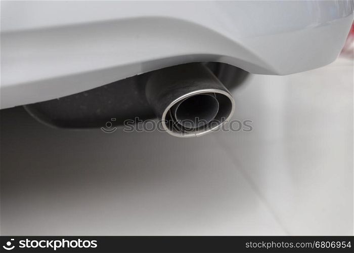exhaust pipe muffler of new white car, selective focus
