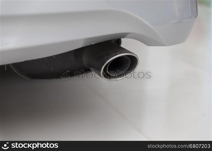 exhaust pipe muffler of new white car, selective focus