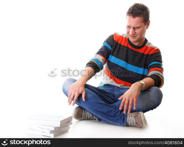 Exhausted and tired student with pile of books on white background