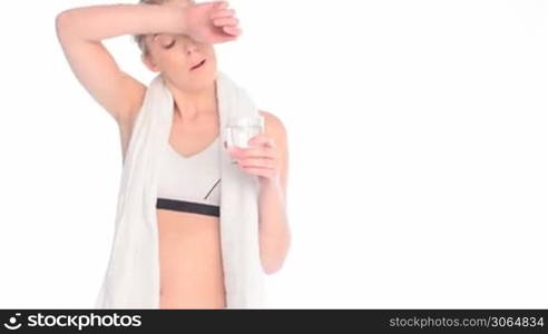 exhausted blonde woman drinking water after workout